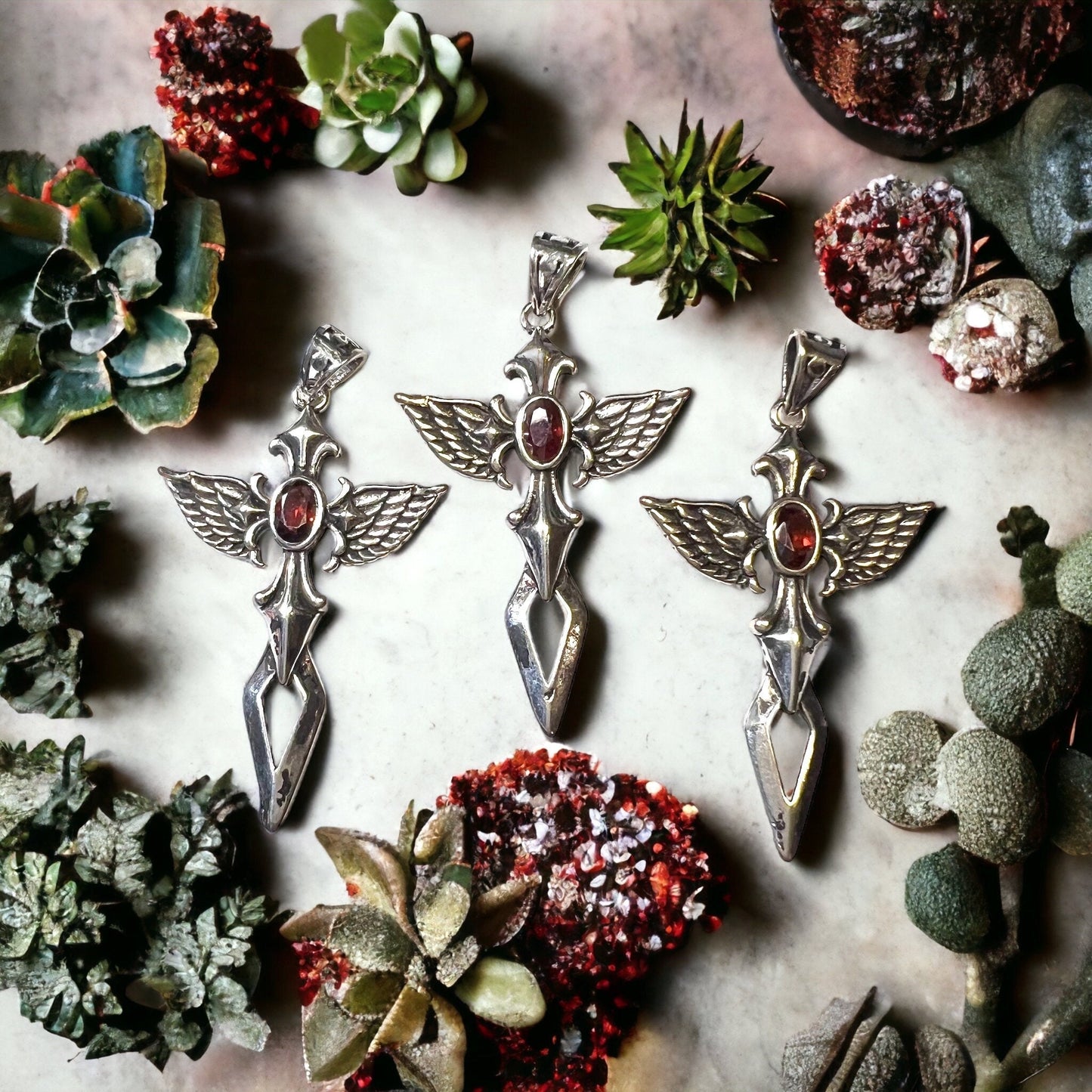 Cross with Angel Wings and a Garnet Pendant