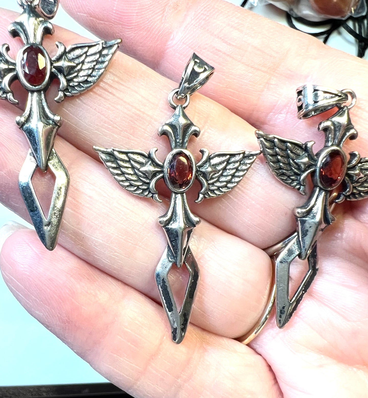 Cross with Angel Wings and a Garnet Pendant