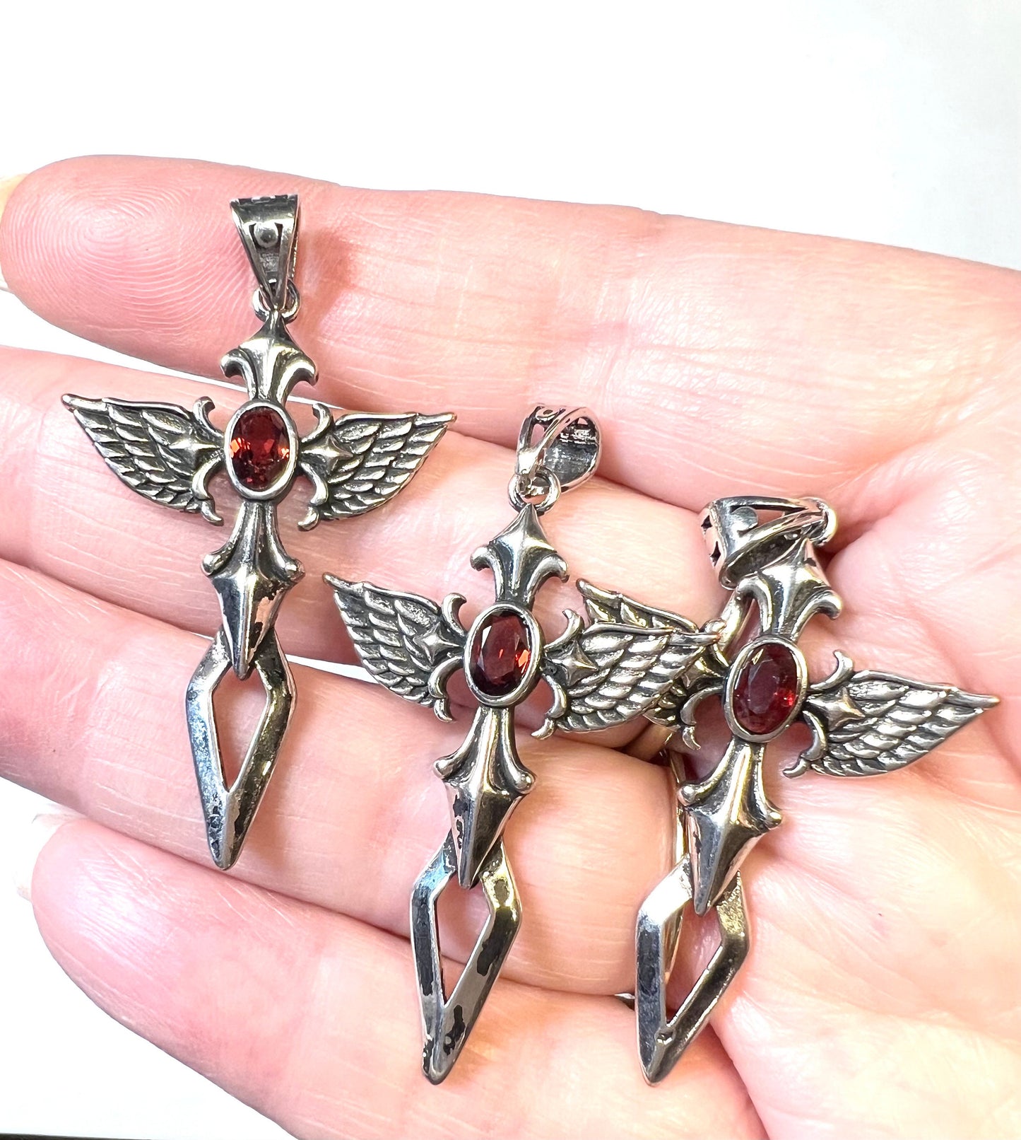 Cross with Angel Wings and a Garnet Pendant