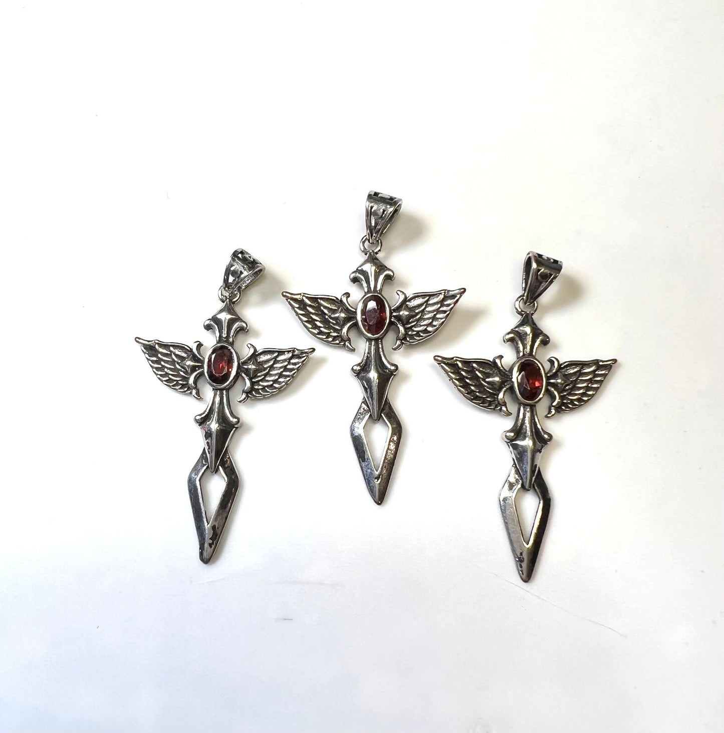 Cross with Angel Wings and a Garnet Pendant