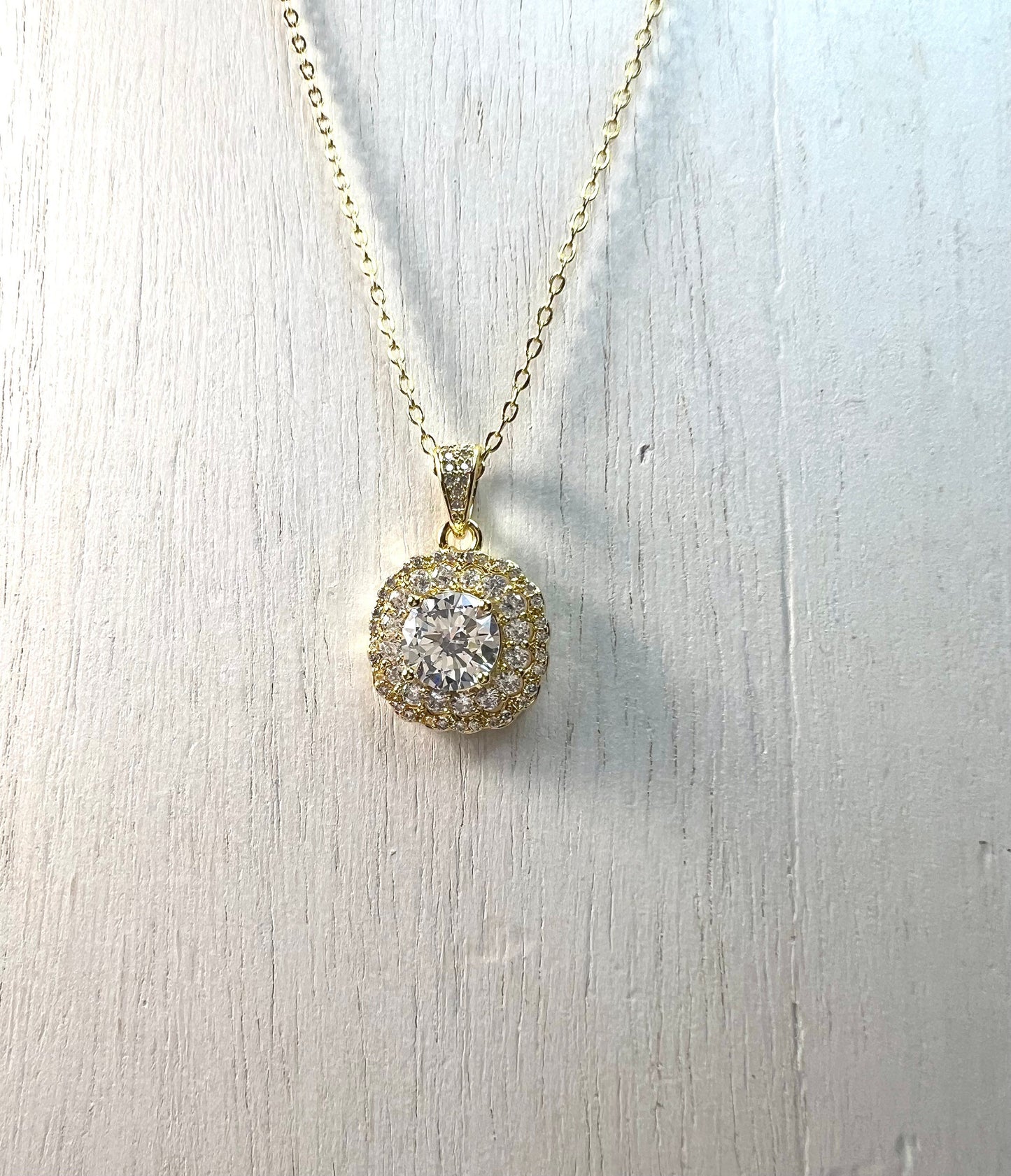 White Zircons in a gold toned setting, with Crystals Pendant